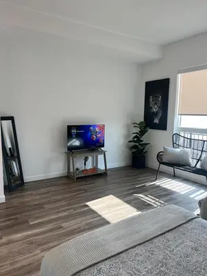 a living room with a flat screen tv on a wall at The sunset loft apartment FREE parking in Los Angeles