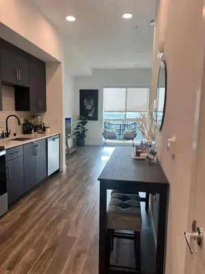 a kitchen and living room with a table and a dining room at The sunset loft apartment FREE parking in Los Angeles