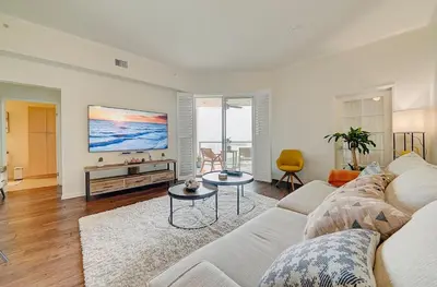 a living room with a couch and a tv at Ocean View Suite by Convention Center & Beach in Long Beach