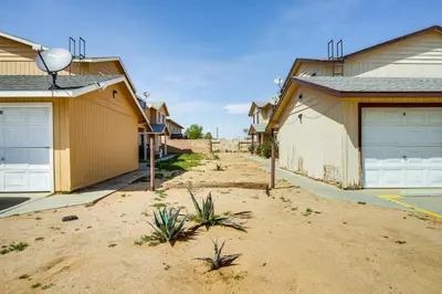 a house with two garage doors in a yard at Patio and Mtn Views Family Gem in California City in California City