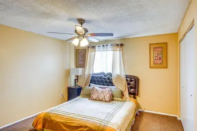 a bedroom with a bed with a ceiling fan at Patio and Mtn Views Family Gem in California City in California City