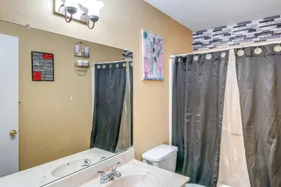 a bathroom with a sink and a toilet and a shower at Patio and Mtn Views Family Gem in California City in California City