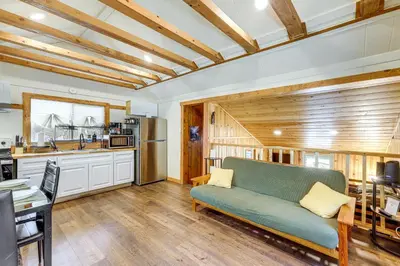 a living room with a couch and a kitchen at Tiny Home with Deck and Mtn Views in Lake Arrowhead! in Lake Arrowhead