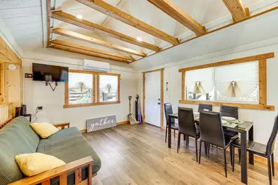 a living room with a couch and a table at Tiny Home with Deck and Mtn Views in Lake Arrowhead! in Lake Arrowhead