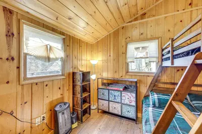 a log cabin with a bunk bed and two windows at Tiny Home with Deck and Mtn Views in Lake Arrowhead! in Lake Arrowhead