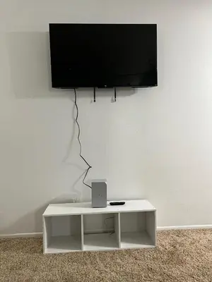 a flat screen tv hanging on a white wall at Starlight Studio near Sunset in Los Angeles