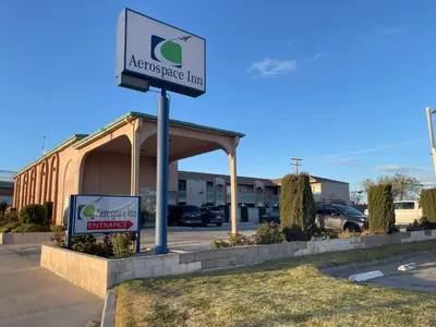 a sign for anassurance hub in a parking lot at Aerospace Inn in Mojave