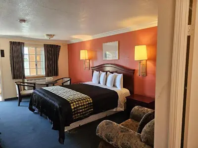 a hotel room with a bed and a desk at Aerospace Inn in Mojave