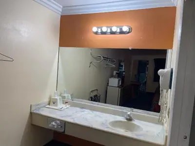 a bathroom with a sink and a mirror at Aerospace Inn in Mojave