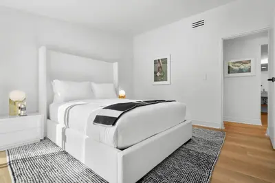 a white bedroom with a white bed and a rug at Malibu Beach House by Stay Awhile Villas in Malibu