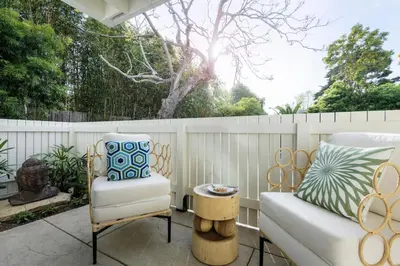 a patio with a couch and a chair at Outdoor Spaces and Coastal Sanctuary in Summerland