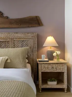 a bedroom with a bed and a table with a lamp at Private Garden and Tranquil Haven in Summerland