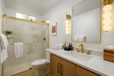 a bathroom with a toilet and a sink and a shower at Private Garden and Tranquil Haven in Summerland