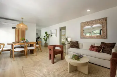 a living room with a couch and a table at Private Garden and Tranquil Haven in Summerland