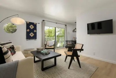 a living room with a couch and a table at Sunny Getaway and 10 Min to SB in Summerland