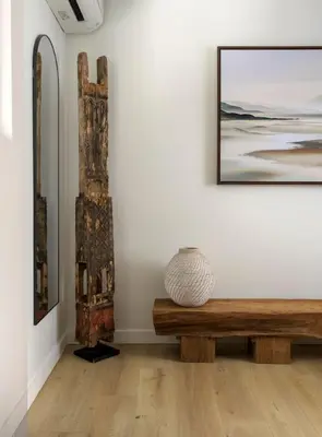 a room with a bench and a vase on a wall at Private Balcony and Coastal Escape in Summerland