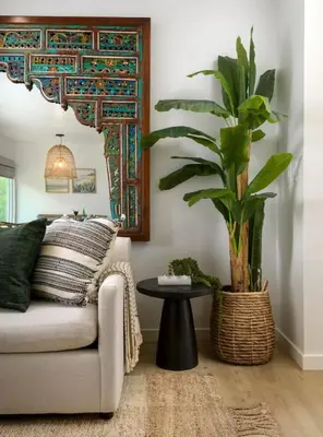 a living room with a couch and a potted plant at Group-Friendly and Tranquil Oasis in Summerland