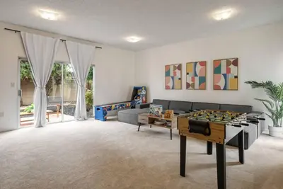 a living room with a couch and a table at Vintage Vibes Near Airport Games Sleeps 8 in Long Beach