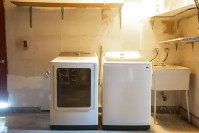 a kitchen with a stove and a sink in a room at Vintage Vibes Near Airport Games Sleeps 8 in Long Beach