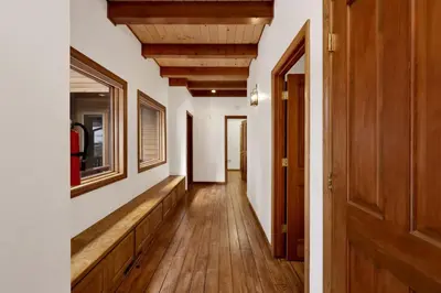 a hallway of a house with wooden floors and wooden ceilings at Bear Lake Lodge Lakefront Incredible Lake House Chalet in Big Bear Lake