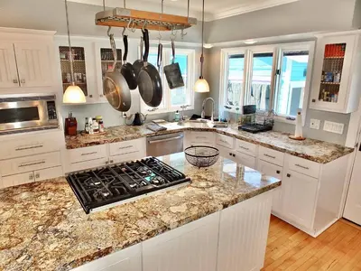 a kitchen with white cabinets and granite counter tops at Beach City Craftsman - Walk to Beach in Long Beach