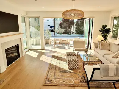 a living room with a couch and a fireplace at Beach Paradise - Stunning 3-Story in Long Beach in Long Beach