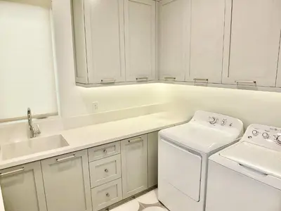 a white kitchen with a sink and a washing machine at Beach Paradise - Stunning 3-Story in Long Beach in Long Beach