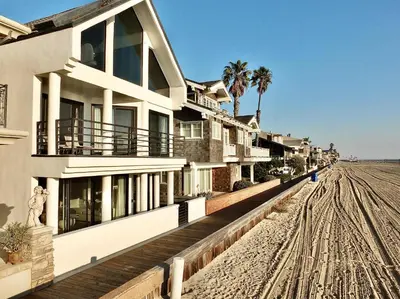 a building on the beach next to a dirt road at Beachfront Estate - LB Peninsula in Long Beach