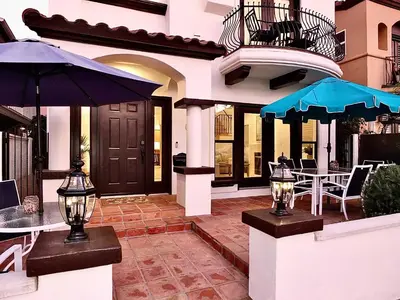 a house with a patio with tables and umbrellas at Beauty by the Beach - SoCal Fun in Long Beach