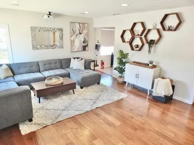 a living room with a couch and a table at Bellflower Breeze - Charming 3 BDR in Long Beach in Long Beach