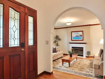 a living room with an archway and a fireplace at Belmont Heights Retreat - Stunning Gardens in Long Beach