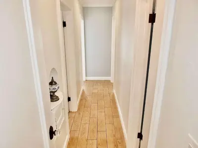 a hallway with white walls and a wooden floor at Belmont Shore Beach House - Incredible Oceanfront Views in Long Beach