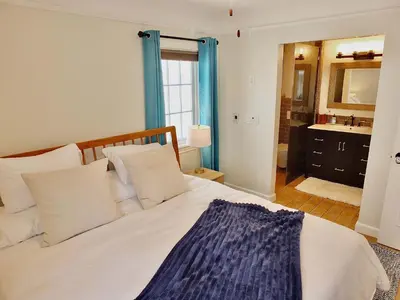 a bedroom with a bed and a bathroom with a sink at Belmont Shore Beach House - Incredible Oceanfront Views in Long Beach