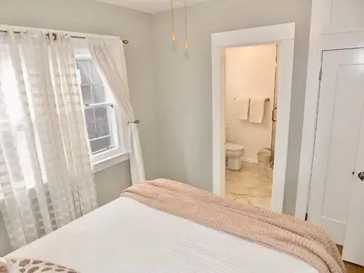 a bedroom with a bed and a bathroom at Steps to Beach & Alamitos Bay on LB Peninsula in Long Beach