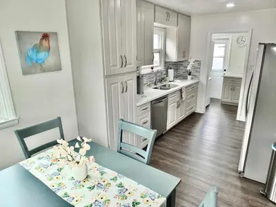 a kitchen with a table and chairs and a kitchen with a counter at Greenbelt Guesthouse - Unlimited Peace & Privacy Golf Bowling Green & More in Long Beach