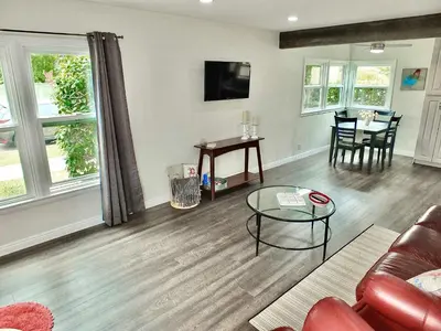 a living room with a couch and a table at Greenbelt Guesthouse - Unlimited Peace & Privacy Golf Bowling Green & More in Long Beach