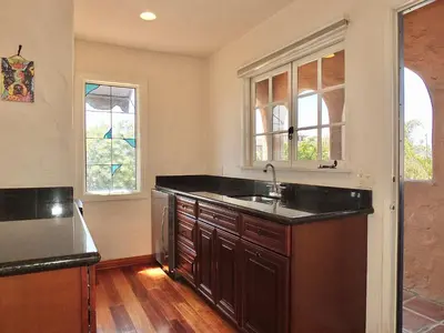 a kitchen with a sink and two windows at La Brisa - One Block from the Beach in Long Beach