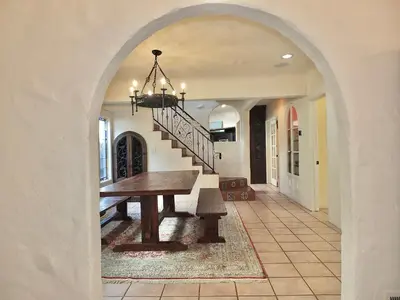 a hallway with a table and stairs in a house at La Brisa - One Block from the Beach in Long Beach