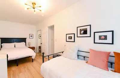 a bedroom with two beds and a ceiling fan at Immaculate 3BDR Bungalow - 5-Min Walk to Beach in Long Beach