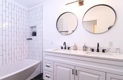a white bathroom with a tub and a sink and mirror at Immaculate 3BDR Bungalow - 5-Min Walk to Beach in Long Beach