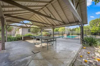 a patio with a ping pong table and a pool at The Otsego Hideaway in Los Angeles