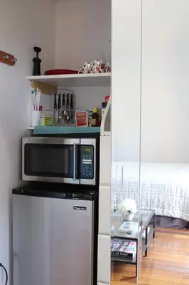 a kitchen with a microwave on top of a refrigerator at Sweet Dreams B&B LA in Sherman Oaks