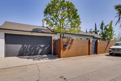 a car parked in front of a house with a garage at Walk to Sunset Strip Modern Home in WeHo Hills! in Los Angeles