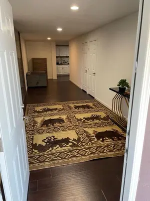 a hallway with a rug with horses on it at Cozy 2 BR Apartment Glendale in Glendale