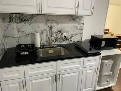 a kitchen counter with a sink and a microwave at Cozy 2 BR Apartment Glendale in Glendale