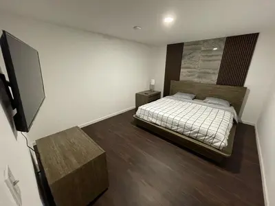 a bedroom with a bed and a television in it at Cozy 2 BR Apartment Glendale in Glendale