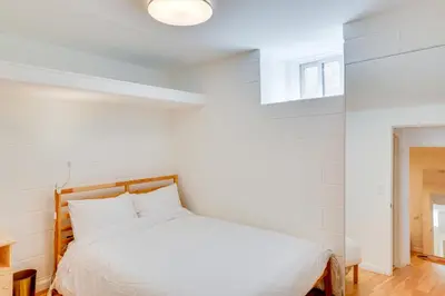 a white bedroom with a bed and a window at 5 Mi to Dtwn Los Angeles Apt with Outdoor Space! in Los Angeles