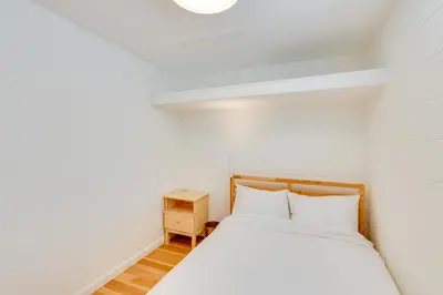 a small bedroom with a bed and a night stand at 5 Mi to Dtwn Los Angeles Apt with Outdoor Space! in Los Angeles