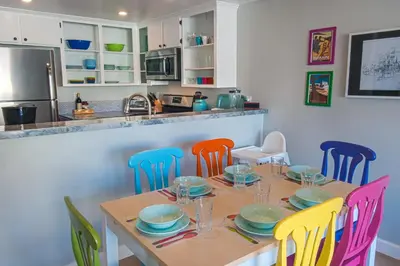 a dining room with a table with colorful chairs at Love Bug by Funtierland Vacation Rentals in Anaheim