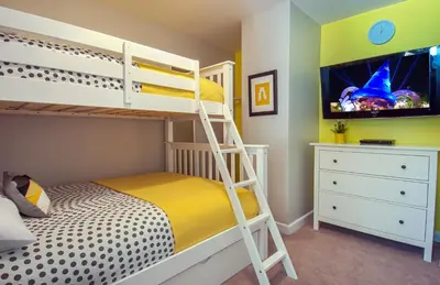 a bedroom with a bunk bed and a tv at Love Bug by Funtierland Vacation Rentals in Anaheim